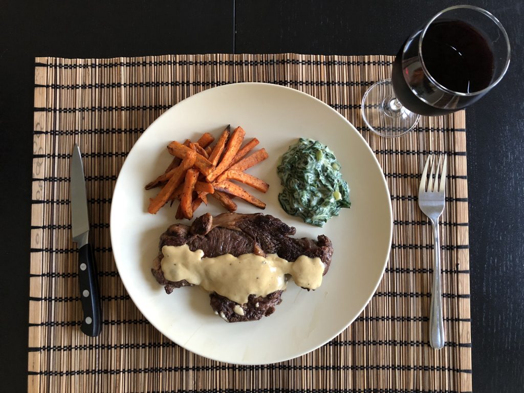 Pan-Seared Steak with Mustard Cream Sauce, Sweet Potato Fries, and Creamed Spinach